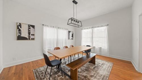 a dining room with a wooden table and chairs at Modern Moroccan Villa w/ Firepit, BBQ + Game Room! in Tampa