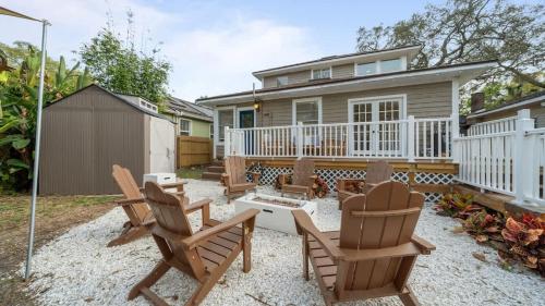 a backyard with rocking chairs and a house at Modern Moroccan Villa w/ Firepit, BBQ + Game Room! in Tampa