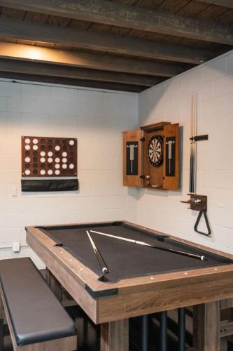 a pool table in a room with a clock on the wall at Modern Cabin with Luxury Gym, Firepit + Game Room! in Blue Ridge