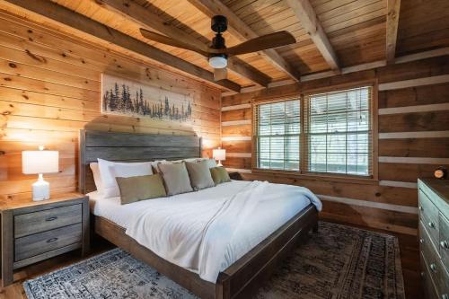 a bedroom with a bed in a wooden cabin at Modern Cabin with Luxury Gym, Firepit + Game Room! in Blue Ridge