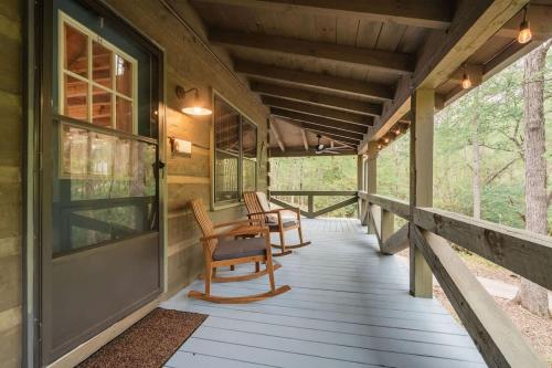 a porch of a cabin with rocking chairs on it at Modern Cabin with Luxury Gym, Firepit + Game Room! in Blue Ridge