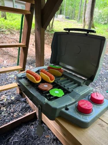 a grill with hot dogs and donuts on it at Modern Cabin with Luxury Gym, Firepit + Game Room! in Blue Ridge