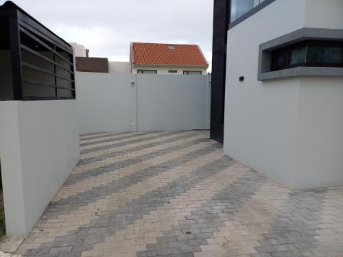a white fence in front of a house at Casa SC in Azogues