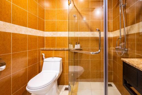 a bathroom with a toilet and a shower at Pandanus Resort in Mui Ne
