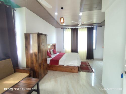 a bedroom with a bed in a room with windows at Green Dandi Homestay in Rāni Pokhri
