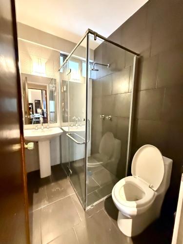 a bathroom with a shower and a toilet and a sink at RMS Suites - Zona Rosa in Mexico City