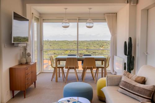 - un salon avec une table, des chaises et une grande fenêtre dans l'établissement Vue superbe sur l’océan, la plage à vos pieds !, à Soorts-Hossegor