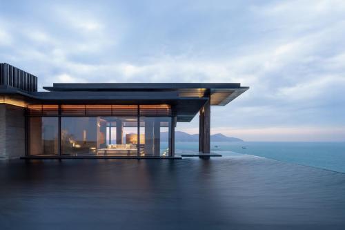 a building on a deck with the ocean in the background at Alila Dong'Ao Island Zhuhai in Zhuhai