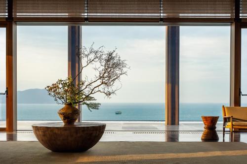 a large room with a large window with a view of the ocean at Alila Dong'Ao Island Zhuhai in Zhuhai