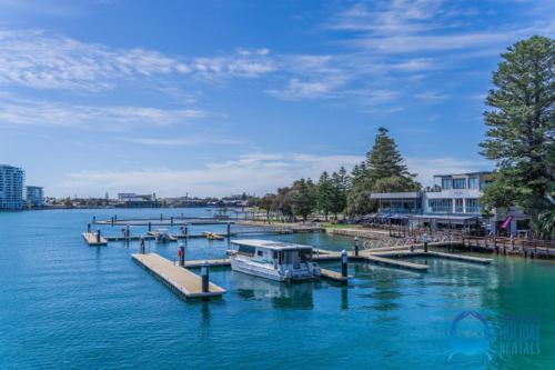 a group of boats docked at a dock in the water at Coastal Canal Retreat in Mandurah in Mandurah