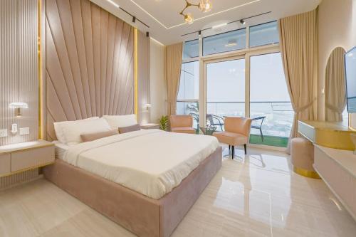 a bedroom with a large bed and a large window at Damac Hills Carson studio on Golf Course in Dubai Marina
