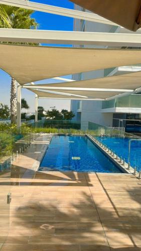 a swimming pool inside of a building with a building at Damac Hills Carson studio on Golf Course in Dubai Marina