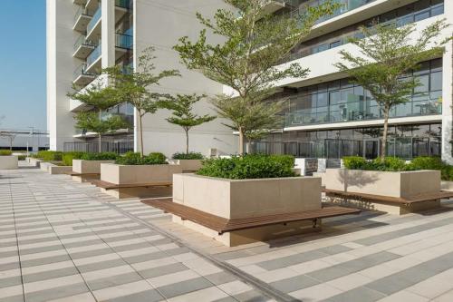 a row of benches in front of a building at Designer 1BR I Golf View I Comfortably Sleeps 4 in Dubai