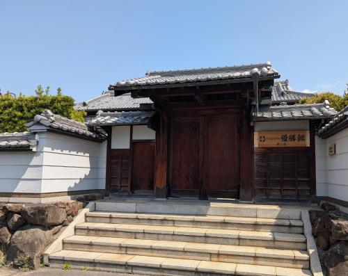 a small building with stairs in front of it at RYOKAN優勝館Hotel in Osaka