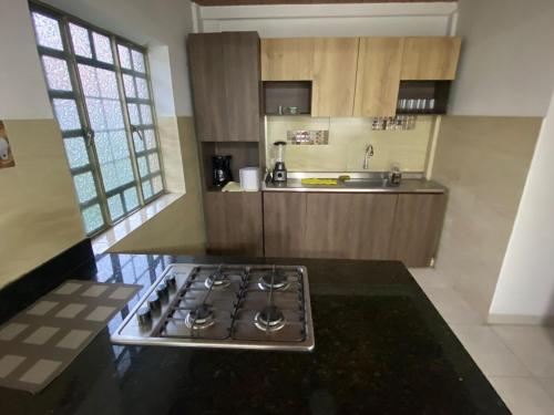 a kitchen with a stove top oven in a kitchen at Casa Santa María in Bogotá
