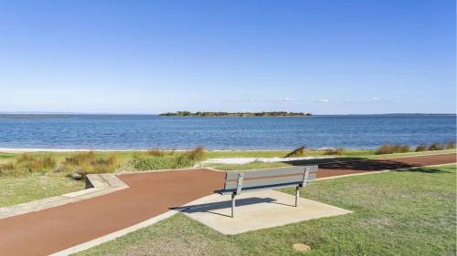 a bench sitting in front of a body of water at Estuary Break in Erskine in Falcon