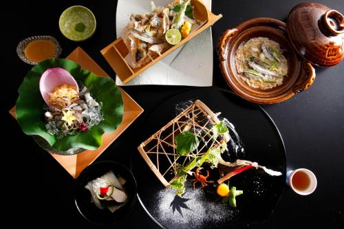 a group of plates of food on a table at Ryokan Beniayu in Nagahama