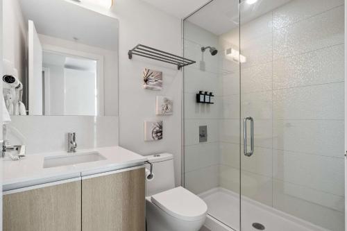 a bathroom with a shower and a toilet and a sink at The Getaway Next to Stampede 2BR Suite Downtown in Calgary
