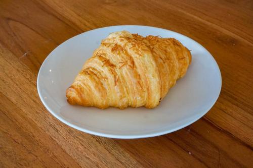 a white plate with a pastry on a wooden table at La Tano's Canggu in Canggu