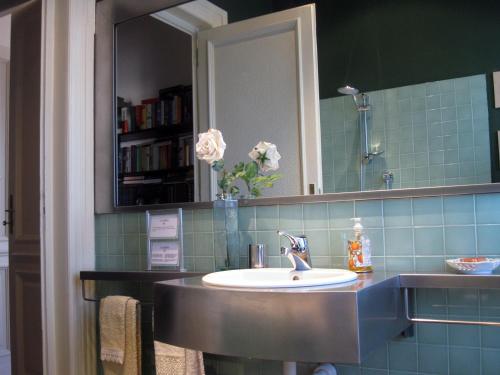 a bathroom with a sink and a mirror at A Casa Armenia B&B in Turin