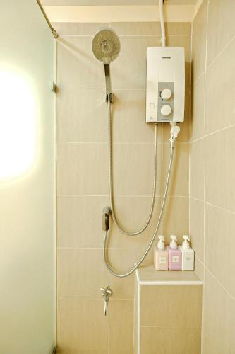 a shower with a shower head in a bathroom at Thong Poon Apartment Chiang Mai in Chiang Mai