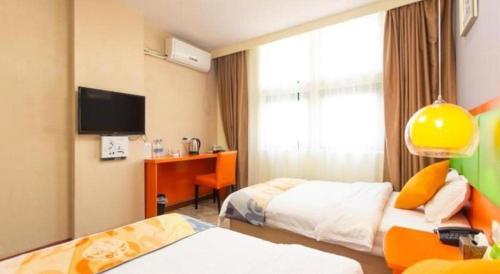 a hotel room with two beds and a window at Shell Hotel Yangzhou Yangzijiang Bei Road Slender West Lake Scenic Area in Yangzhou