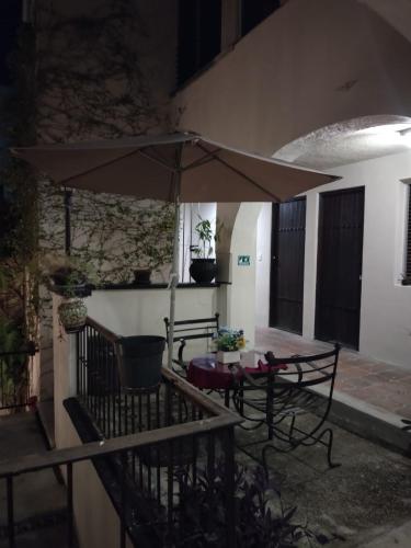 a patio with a table and an umbrella at Majaguar Hotel Boutique in Cancún