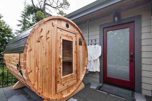 a wooden sauna with a wooden door on a house at Suite Ucluelet in Ucluelet