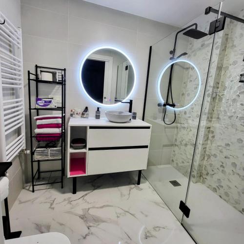 a white bathroom with a sink and a mirror at Apartamento Leurtza in Doneztebe