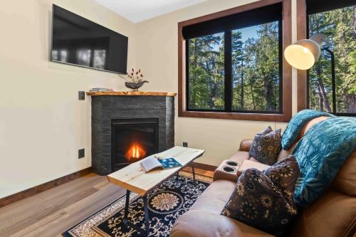 a living room with a couch and a fireplace at Suite Ucluelet in Ucluelet