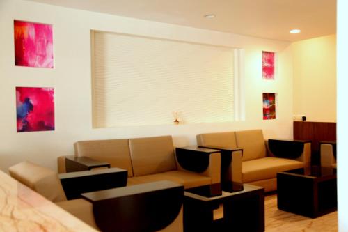a living room with a couch and a window at Le Roi Jammu - Near Jammu Railway Station in Jammu