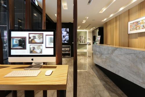 a computer sitting on a desk in a room at Miller Inn in Taichung