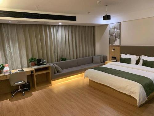 une chambre d'hôtel avec un lit et un canapé dans l'établissement GreenTree Inn Jiangsu Nantong Rudong County Changsha Town Government, à Jinjiazhuang