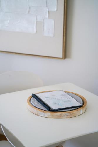 a table with a cell phone and a book on it at Diggers Beach Villa Coffs Harbour in Coffs Harbour