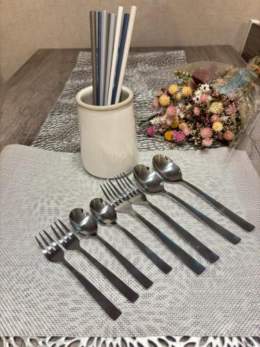 a group of forks and spoons on a table at Stylish Room Near Susukino 2 Beds 205 in Sapporo