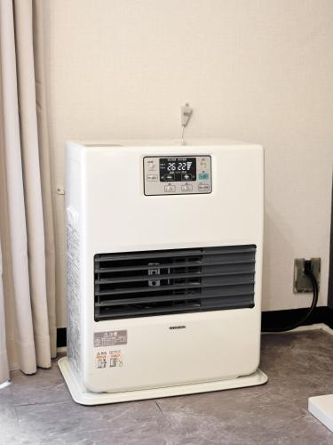 a microwave oven sitting on the floor in a room at Stylish Room Near Susukino 2 Beds 205 in Sapporo