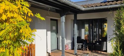 a house with a door and a porch at Le Clos du Haslach in Niederhaslach