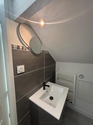 a bathroom with a white sink and a mirror at maison proche plage et centre ville in Les Sables-dʼOlonne