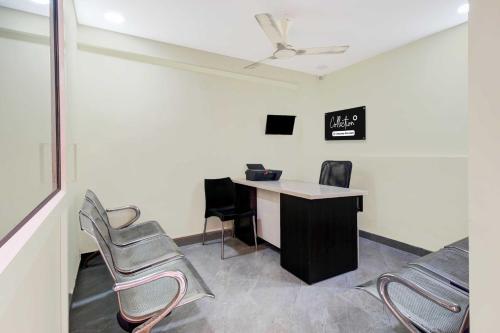 an office with a desk and chairs in a room at Collection O Murali Nagar Near NAD Junction in Visakhapatnam
