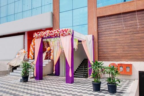 a wedding entrance to a building with a canopy and plants at Collection O Murali Nagar Near NAD Junction in Visakhapatnam