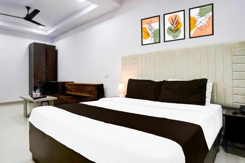 a bedroom with a large bed with a ceiling fan at Collection O Four Bungalow in Upal