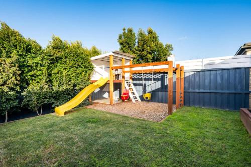 a playground with a slide in a yard at Family-Friendly 4BR Mount Duneed Manor in Mount Duneed