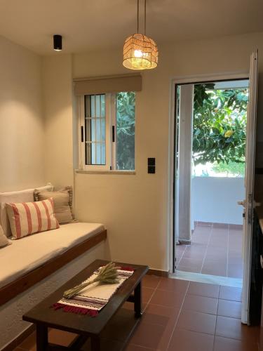 a living room with a couch and a table at Kamara Apartments Marmari in Marmari