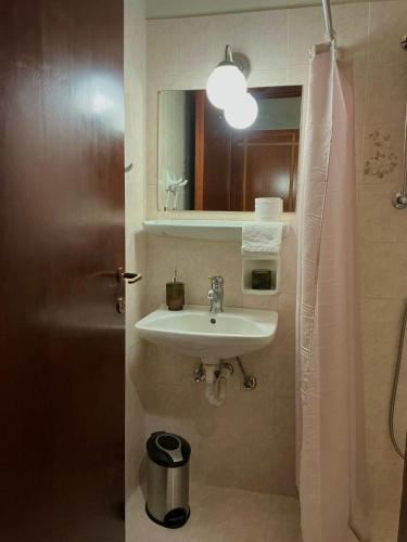 a bathroom with a sink and a mirror at Kamara Apartments Marmari in Marmari