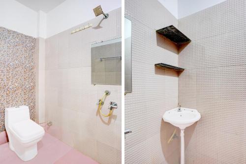 a white bathroom with a toilet and a sink at Collection O Jaggannath Temple Formerly Silver Key in Raipur