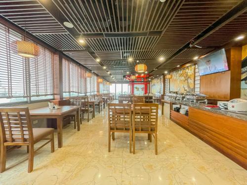 a restaurant with tables and chairs in a room at Azumaya Hotel Dao Tan in Hanoi