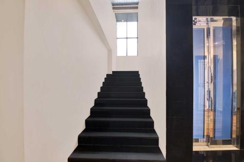 a stairway with black steps and a window at Collection O Chittivalasa Near Bheemili Beach in Visakhapatnam