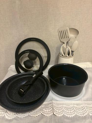 a black frying pan and a bowl on a table at Make Your Hotel Susukino E in Sapporo