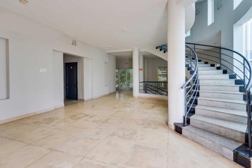 an empty hallway with stairs in a house at Collection O ECR Stays Near Nemmeli Beach in Chennai
