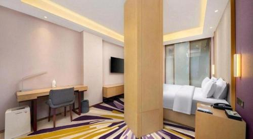 a hotel room with a bed and a desk at Lavande Hotel Changchun Gaoxin Jilin University in Changchun